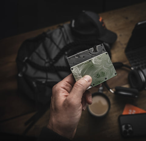 the pocket tripod in card format being inserted into a slim wallet