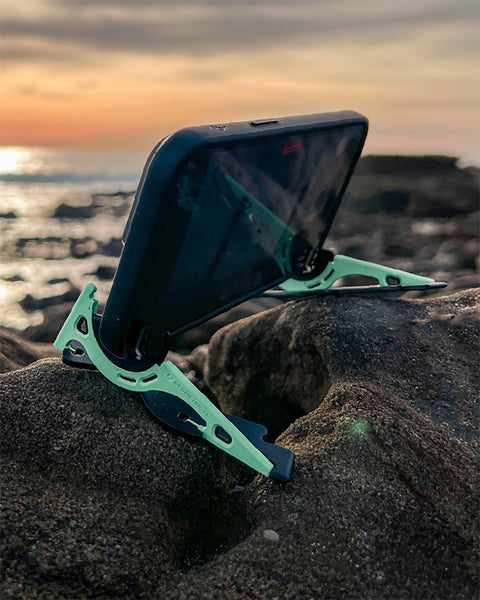The legs of the Pocket Tripod separated to create a wider base and balance a phone on an uneven rocky surface