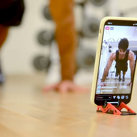 A man sharing his gym workout on Instagram live with his iPhone on the Pocket Tripod