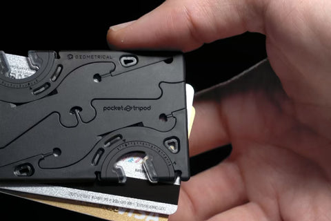A card sized pocket tripod held up with 2 credit cards