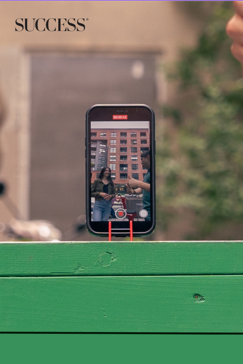 iphone on a pocket tripod on a bench taking a selfie video