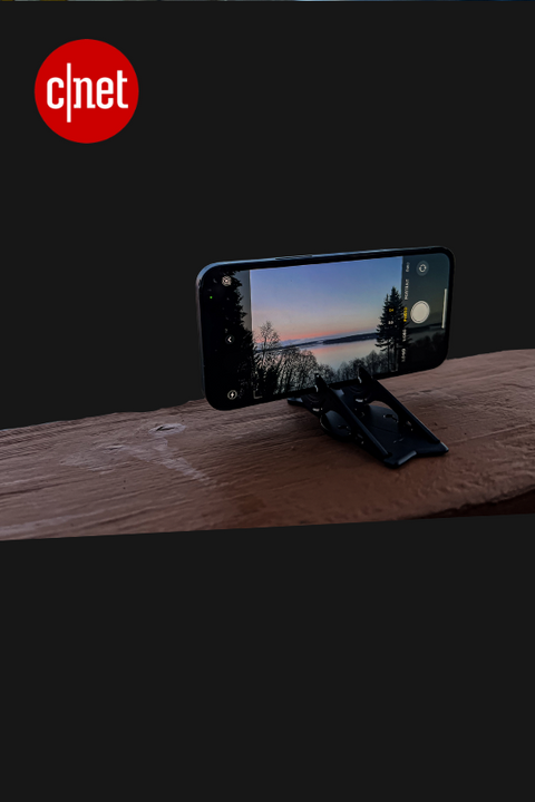 iphone in landscape orientation on a pocket tripod on a wooden beam