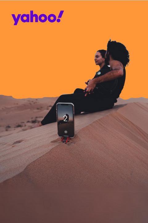 a couple using the pocket tripod with their iphone in the desert of dubai