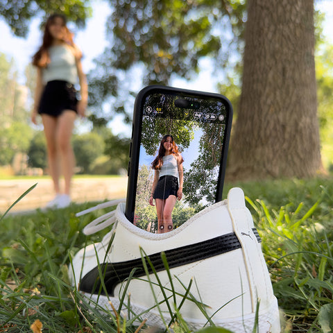 A shoe being used as a stand to hold a phone to take a picture
